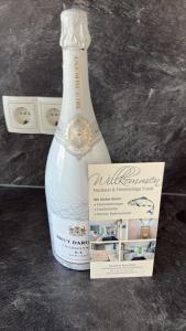 a bottle of wine sitting next to a box at Ferienwohnung Idylle in Wasserburg