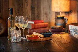 a table with a bottle of wine and wine glasses at The Bold Hotel; BW Signature Collection in Southport