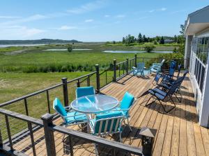 a deck with chairs and a table on a house at Seascape Serenity with Epic Coastal Views! in Lubec +37 photos