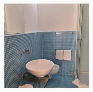 a bathroom with a sink and a toilet and a shower at Masseria Le Celline in Nardò