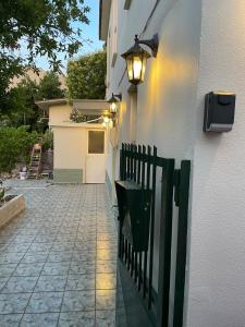 a building with a street light next to a fence at Chalikas Vintage Cottage in Mytilene