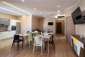 a kitchen and a dining room with tables and chairs at ISA ROOMS Bed&Breakfast in Bovalino Marina +22 photos
