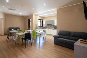 a living room with a couch and tables and chairs at ISA ROOMS Bed&Breakfast in Bovalino Marina