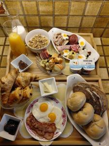 a table with eggs and bread and other breakfast foods at B&B Fleur in Schoten