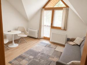 a living room with a couch and a table at Penzion Centrum in Sklené Teplice