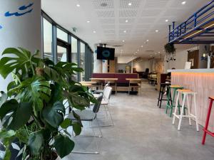 a lobby with tables and chairs and apodcast at ibis Styles Angouleme Centre in Angoulême