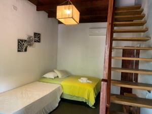 a room with a bed and a stair case at Pousada Kalangoo in Barra Grande