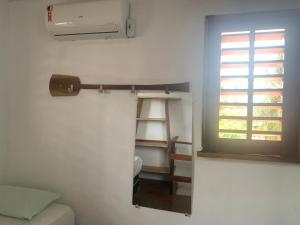 a room with a ladder next to a window at Pousada Kalangoo in Barra Grande