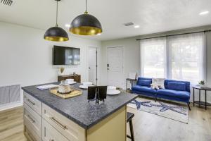a kitchen and living room with a blue couch at Steinhatchee River Hideaway, 1 Mi to the Water! in Steinhatchee