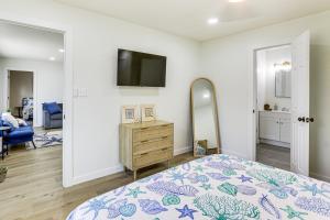 a bedroom with a bed and a mirror at Steinhatchee River Hideaway, 1 Mi to the Water! in Steinhatchee