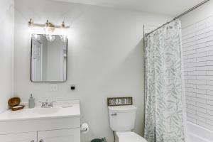 a bathroom with a toilet and a sink and a mirror at Steinhatchee River Hideaway, 1 Mi to the Water! in Steinhatchee +15 photos