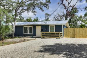 a small blue house with a wooden fence at Steinhatchee River Hideaway, 1 Mi to the Water! in Steinhatchee