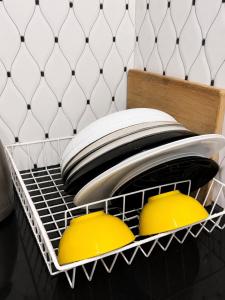 a rack with plates and bowls in a room at Home23 Apartments in Jinja