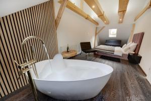 a white bath tub in a room with a bedroom at Luxury Heaven Apartment - 116 m2 Fireplace 3 bedroom - Free Parking in Katowice +77 photos