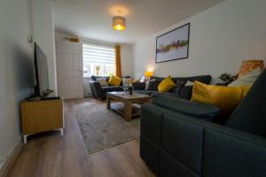 a living room with a couch and a table at Spacious 5BR Home St Andrews in Fife