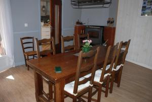 a dining room with a wooden table and chairs at Chambres d hôtes Avalanche du rock in Buzy +12 photos