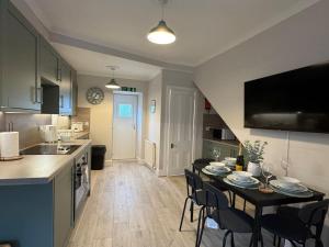 a kitchen and dining room with a table and chairs at Modern 3BR home in Cumbernauld in Cumbernauld