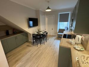 a kitchen and living room with a table and chairs at Modern 3BR home in Cumbernauld in Cumbernauld