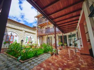 an exterior view of a house with a patio at Hostal Catequil in Cajamarca
