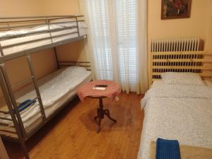 a bedroom with two bunk beds and a table at Christos IIII in Asvestokhórion