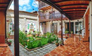 an indoor courtyard of a house with plants at Hostal Catequil in Cajamarca