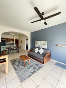a living room with a couch and a ceiling fan at Punto Mita Eco Surf Suites in Punta Mita
