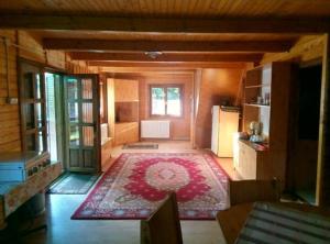a living room with a large rug on the floor at Cabana DUY-KAY in Lacu Rosu