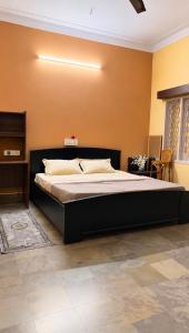 a bedroom with a large bed in a room at Clean Culture Retreat in Mysore