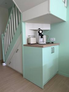 a kitchen with a counter top and a staircase at Le refuge de Notre-Dame in Berck-sur-Mer +6 photos