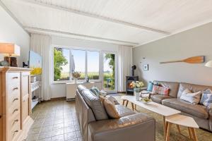 a living room with a couch and a table at Ferienhaus Marienleuchte in Marienleuchte