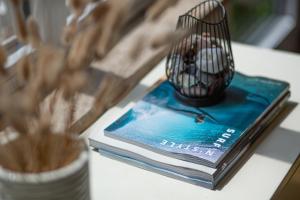 a book with a bird cage on top of it at Ferienhaus Marienleuchte in Marienleuchte