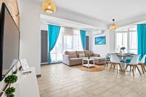 a living room with a couch and a table at Bavaro 50 by Alezzi Resort in Mamaia Sat/Năvodari