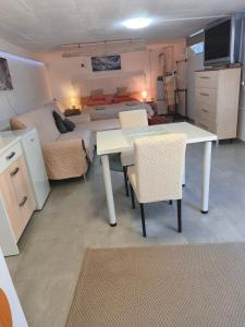 a small room with a table and a bed at Slanraj Studio in Jadrtovac +4 photos