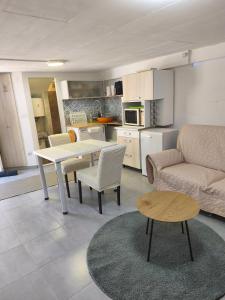 a living room with a table and a couch at Slanraj Studio in Jadrtovac