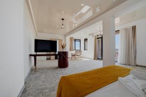 a bedroom with a bed and a flat screen tv at Complex PopDan in Costinesti
