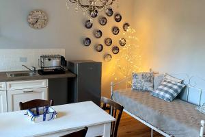 a kitchen with a couch and a table in a room at Cascina Vica Biella in Andorno Micca