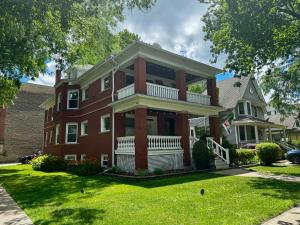 a large red brick house with a porch at Elegant and Chic 2Bed 2Bath steps from the lake! in Chicago