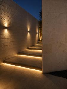 a staircase with lights on the side of a building at Hummingbird Dubai in Dubai