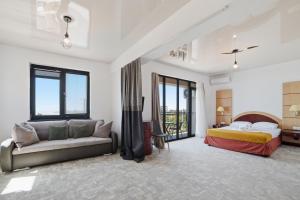 a bedroom with a bed and a couch at Complex PopDan in Costinesti +48 photos