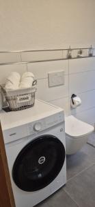 a laundry room with a washing machine and a toilet at Casa Laguna in Oberteuringen +38 photos