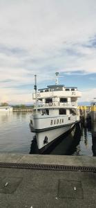 a white boat is docked at a dock at Casa Laguna in Oberteuringen