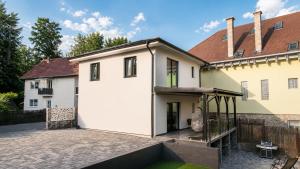 an external view of a house with a courtyard at Cataleya House Sovata in Sovata