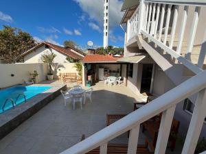 a house with a patio and a swimming pool at Pousada da Igreja in Pântano Grande