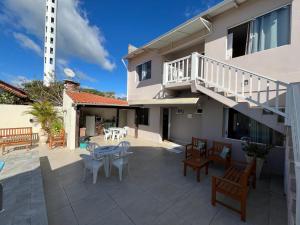 a patio with a table and chairs and a building at Pousada da Igreja in Pântano Grande