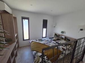 a bedroom with a bed in a room at La Casadrine in Le Grau-dʼAgde