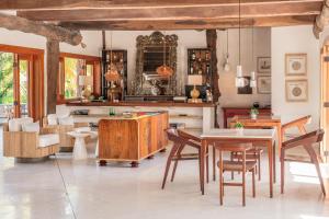 a kitchen and dining room with wooden tables and chairs at Ser Casasandra Boutique Hotel in Holbox Island