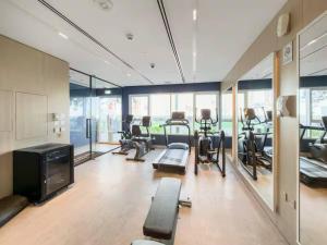 a gym with treadmills and cardio equipment in a room at FIRST CLASS 1BR Cozy Luxury Retreat in ‘Ūd al Bayḑāʼ