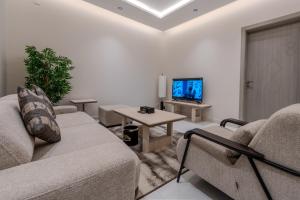 a living room with two couches and a tv at wend house in Jeddah