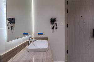 a bathroom with a white toilet sitting next to a door at wend house in Jeddah +48 photos
