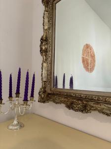 a group of purple candles in front of a mirror at art apartament cerea in Cerea
